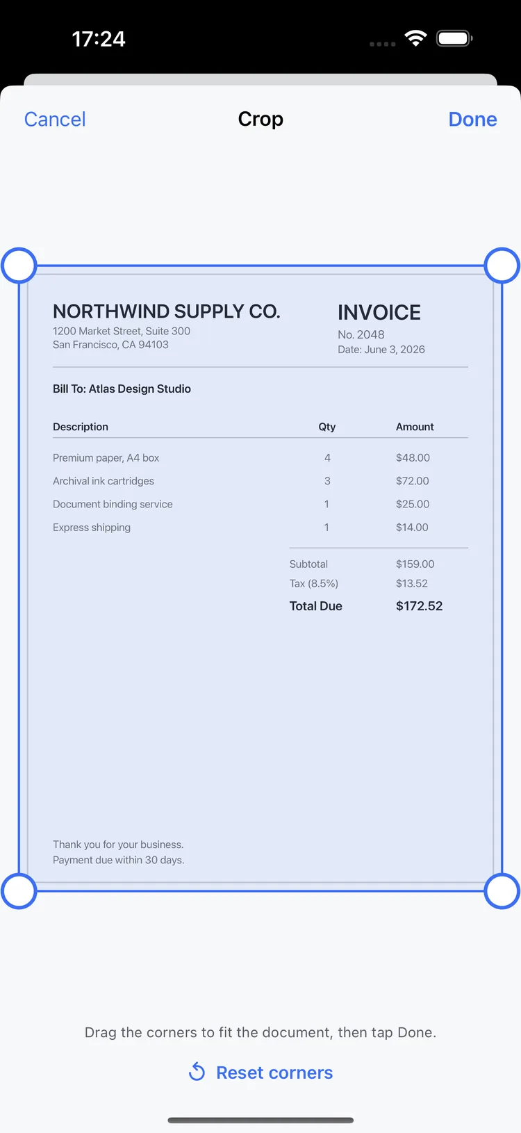 The crop editor in Scanmint with draggable corner handles over a scanned invoice